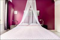 a large bed with a canopy in a purple room at Apt Chic, 60m2, 2 Chambres, Centre in Valenciennes