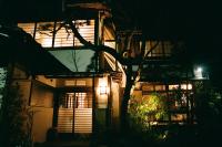 un edificio con un árbol delante de él por la noche en Hakonowa, en Hakone