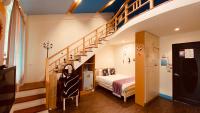 a bedroom with a bed and a staircase at Hai Yang Feng Qing Homestay in Hualien City