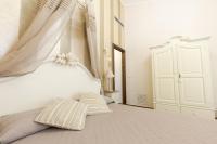 Posteľ alebo postele v izbe v ubytovaní Hotel Villa Calandrino
