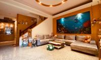 a living room with a couch and a large aquarium at Hai Yang Feng Qing Homestay in Hualien City