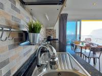A kitchen or kitchenette at Coastview Terrace Studio by TOR