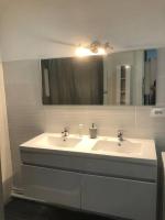 a bathroom with two sinks and a mirror at Appartement all in grey in Agen