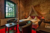 1 dormitorio con 1 cama y sillas en una habitación en Hotel zur Henne, en Naumburg