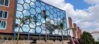 a glass building with trees in front of it at Hotel Camino de Piedra in Guanajuato