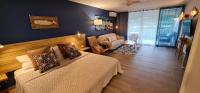 a bedroom with a bed and a living room at Charm and sea, large studio designed by architect in Cul de Sac