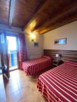 A bed or beds in a room at Aparthotel Areu