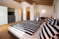 a bedroom with a large bed with black and white stripes at Ferienhaus Reiter Jochberg bei Kitzbühel in Jochberg