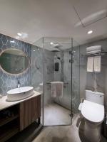 a bathroom with a shower and a toilet and a sink at HINOEN Hotel in Taipei