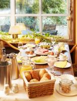 a table with a basket of bread and glasses of wine at Park Hotel Berlin in Bad Fallingbostel