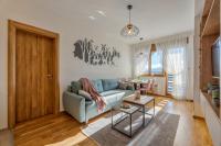 a living room with a blue couch and a table at Apartman Prima Plus in Zlatibor
