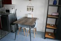 a kitchen with a wooden table and two chairs at escapade en mer in Ault