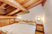 Posteľ alebo postele v izbe v ubytovaní Chalet Meridiana Appartamento 11