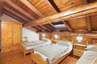 Posteľ alebo postele v izbe v ubytovaní Chalet Meridiana Appartamento 11