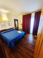Łóżko lub łóżka w pokoju w obiekcie HG Hotel Italia