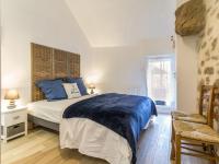 a bedroom with a bed with blue sheets and a window at Gîte Guérande, 3 pièces, 5 personnes - FR-1-306-1197 in Guérande