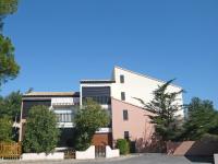 a large white building with trees in front of it at Apartment Les Eaux Vives 1 &amp; 2-5 by Interhome in Saint Pierre La Mer