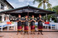 a group of four men standing in front of a restaurant at Absolute Scuba Bali Dive Resort in Padangbai