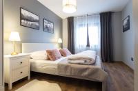 Posteľ alebo postele v izbe v ubytovaní Apartament Henrykówka Apartzakop