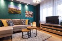 Televízia a/alebo spoločenská miestnosť v ubytovaní Apartament Henrykówka Apartzakop