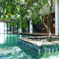 a swimming pool with a tree in the middle at Arachchi Heritage in Anuradhapura