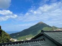 a view of a mountain from a roof at Linyuan Village in Jiufen