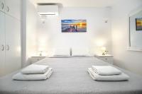 Łóżko lub łóżka w pokoju w obiekcie Anius Apartments