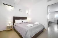 Łóżko lub łóżka w pokoju w obiekcie Anius Apartments