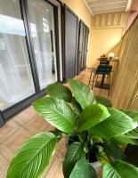 a large green plant in a room with windows at Sélina by Les Suites d&#39;Alfred in Saint-Denis