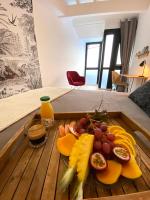 a tray of fruit on a table in a room at Sélina by Les Suites d&#39;Alfred in Saint-Denis