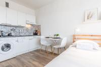 a white apartment with a bed and a kitchen at L&#39;Horizon in Metz