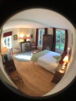 a view of a bedroom with a bed and windows at Maison de vacances _ Le Bas Manoir in Bretteville-sur-Odon