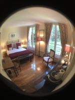 a view of a bedroom with a bed and a living room at Maison de vacances _ Le Bas Manoir in Bretteville-sur-Odon
