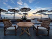 a table and chairs with umbrellas on a patio at Wala Hotel and Beach Club in Cartagena de Indias