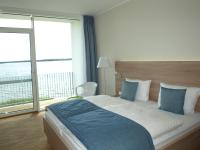 Postel nebo postele na pokoji v ubytování Strandhotel Senftenberger See