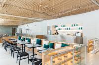 a row of tables and chairs in a restaurant at Shambhala Hotel Pattaya in Pattaya Central