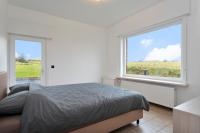 a bedroom with a bed and a large window at Vakantiewoning in het landelijke Staden! 10 pers - STAEDENBERGH in Staden