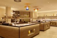 a large kitchen with a large island in the middle at Parkhotel CUP VITALIS in Bad Kissingen