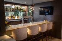 a bar with bar stools in a restaurant at Holiday Inn Toronto Downtown Centre by IHG in Toronto