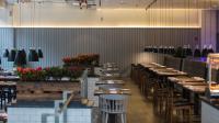 a dining room with tables and chairs and flowers at Paradox Kunshan in Kunshan