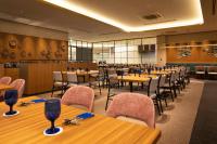 uma sala de jantar com mesas e cadeiras de madeira em ART HOTEL Nippori Lungwood em Tóquio