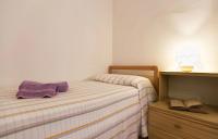A bed or beds in a room at Cervi flat close to the sea and the historic centre of Alghero