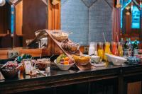 a kitchen counter with bowls of fruit and drinks at Hotel Eiffel Blomet in Paris