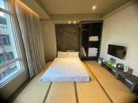 a bedroom with a bed and a large window at Kiwi Express Hotel-Taichung Station II in Taichung