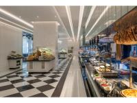 a store with a checkered floor and a food aisle at Kaya Palazzo Resort & Casino in Kérynia