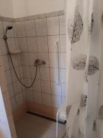 a bathroom with a shower with a shower curtain at Krémer Vendégház in Harkány
