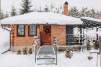 a house covered in snow with a porch at Dolyna Mykolaya in Migovo