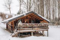 a log cabin with a snow covered roof in the snow at Dolyna Mykolaya in Migovo