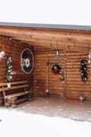 a log cabin with christmas wreaths and a door at Dolyna Mykolaya in Migovo