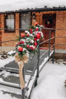 a bunch of flowers on a railing in the snow at Dolyna Mykolaya in Migovo